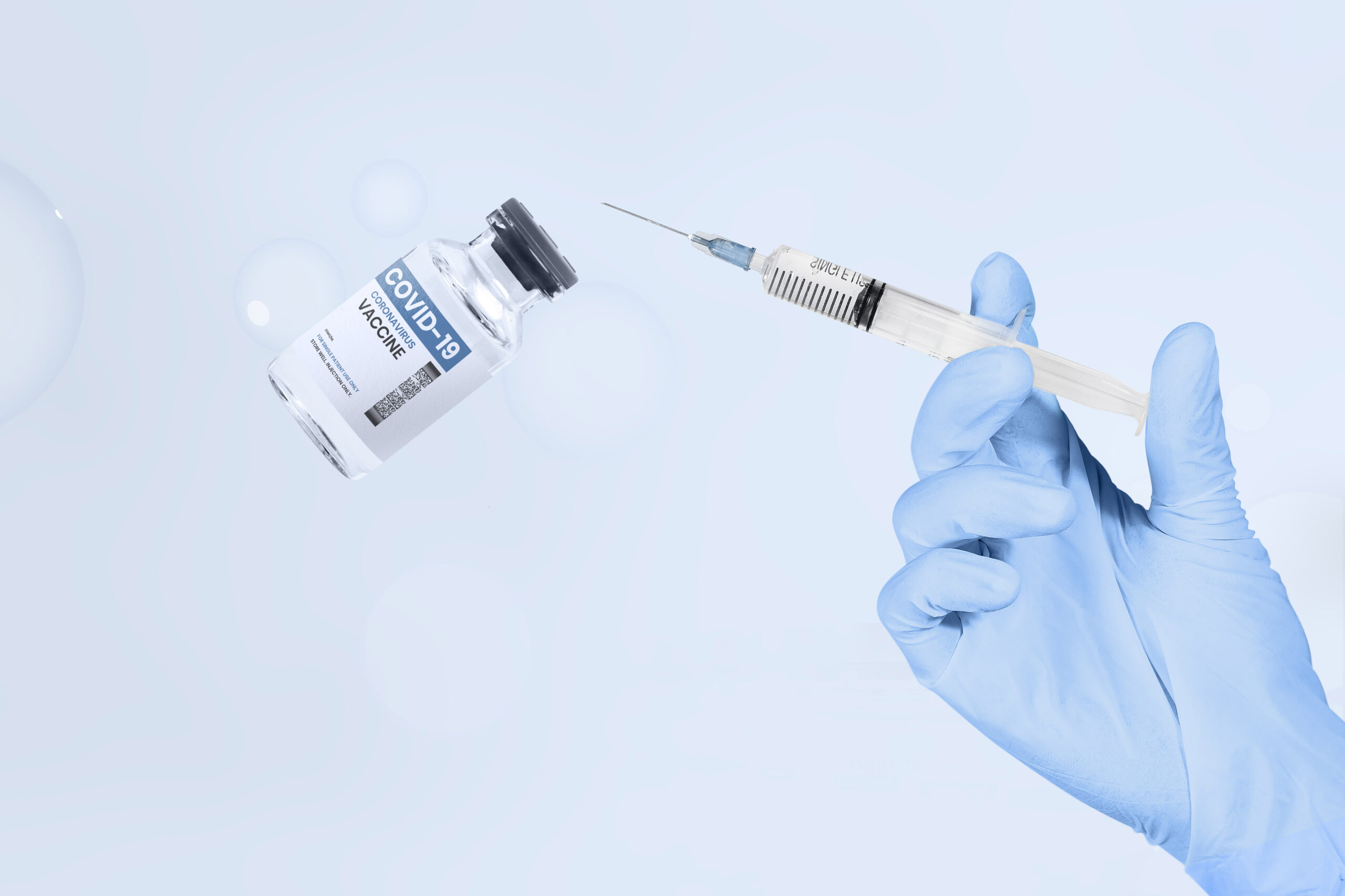 hand-holding-syringe-and-vaccine-vial